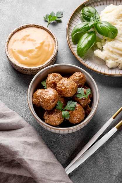 traditional swedish meatballs with creamy sauce and mashed potatoes on gray background