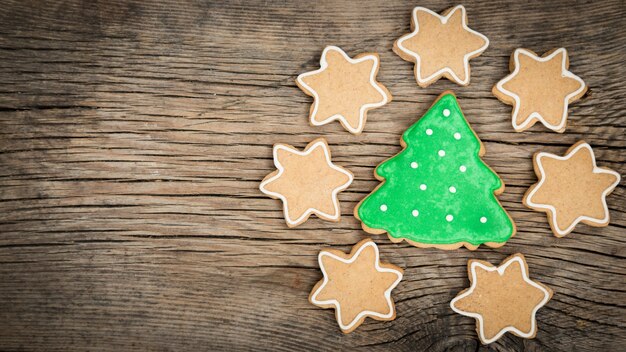 Traditional sweet Christmas cookies on wooden background