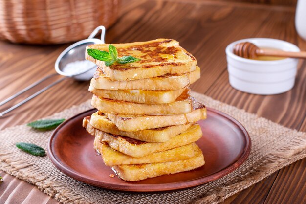 Traditional sweet fried toasts with honey and mint. Delicious breakfast.