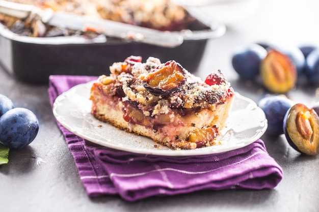 The traditional sweet plum cake on white plate.