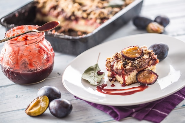 The traditional sweet plum cake on white plate.