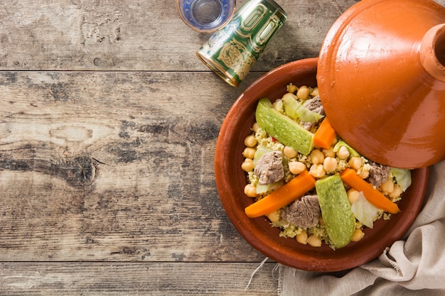 Traditional tajine with vegetables, chickpeas, meat, and couscous