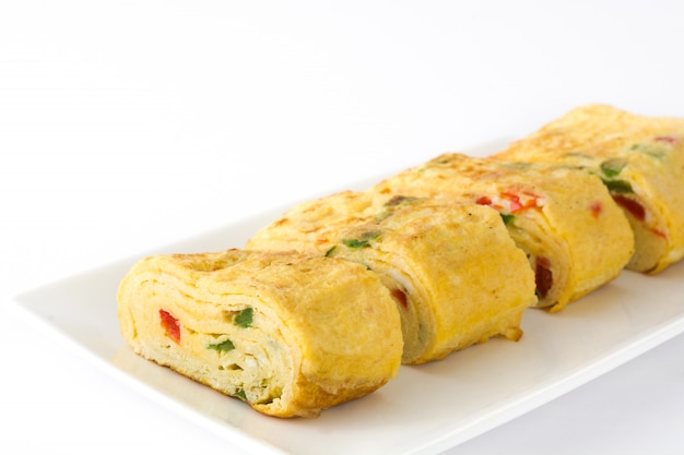 Traditional tamagoyaki Japanese omelette isolated on white surface