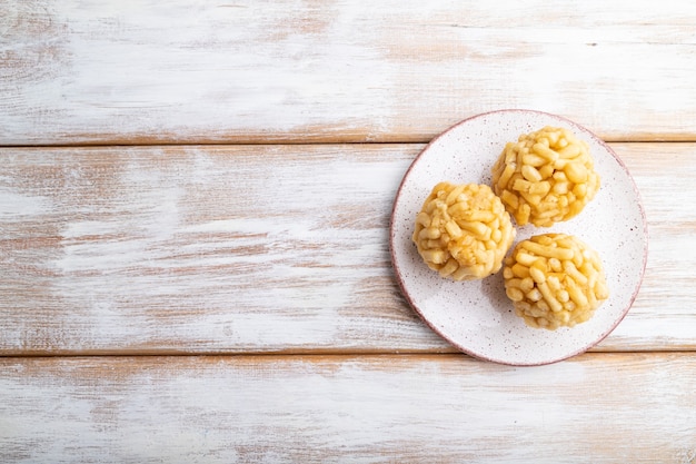 Foto chak-chak tradizionale della caramella tartara fatta di pasta e miele su un fondo di legno bianco. vista dall'alto, piatto laico, copia dello spazio.