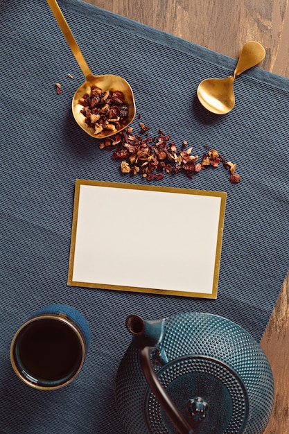 Traditional tea ceremony setup, teapot and teacup with herbs and dry fruits tea. Tisane detox, relaxation, healing, healthy comforting, tea time concept. Top view, flat lay