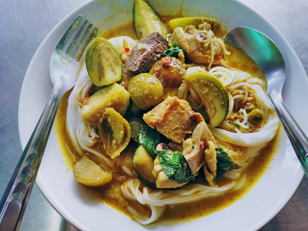 Traditional Thai Food. Rice Noodles with Green Curry Chicken.