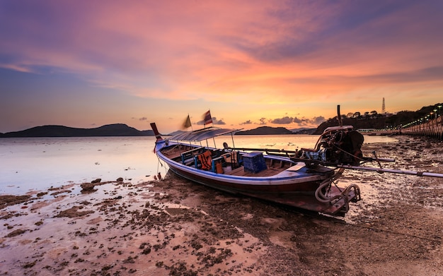 Traditional Thai longtail boat at sunrise beach in Phuket, Thailand