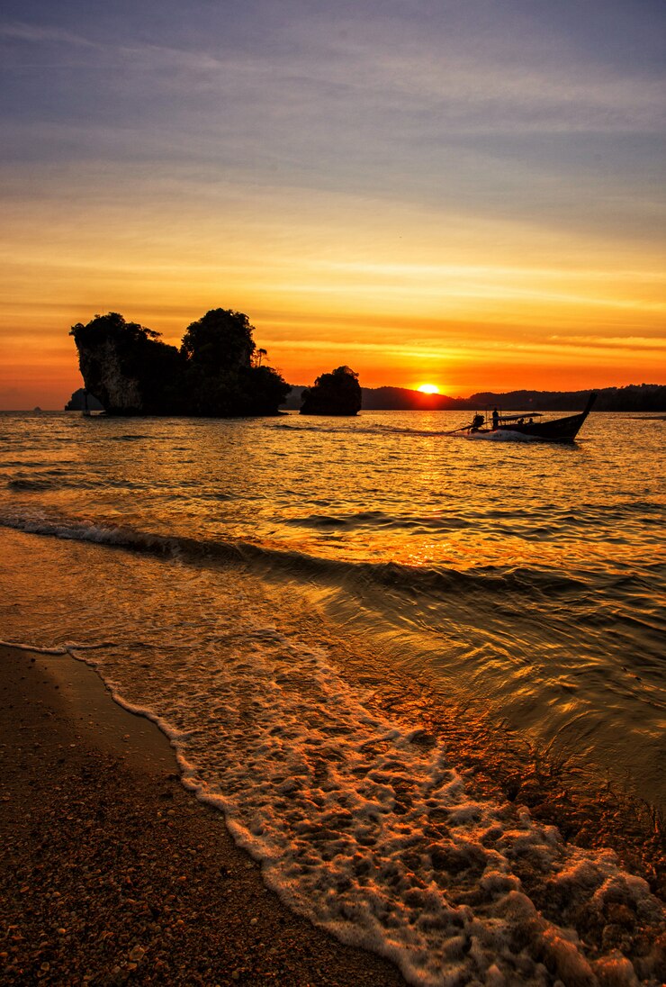 Traditional thai longtail boat at sunset on the Beach
