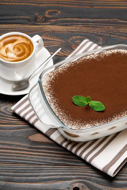 Traditional tiramisu dessert in glass baking dish