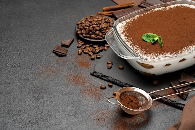 Traditional tiramisu dessert in glass baking dish