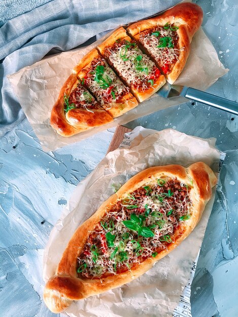 Traditional Turkish baked dish pide with meat filling.