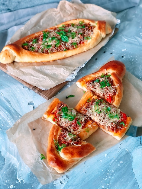 Traditional Turkish baked dish pide with meat filling.