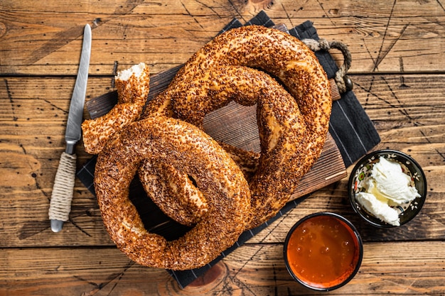 Traditional turkish breakfast with Bagel Simit kaymak and honey Wooden background Top view