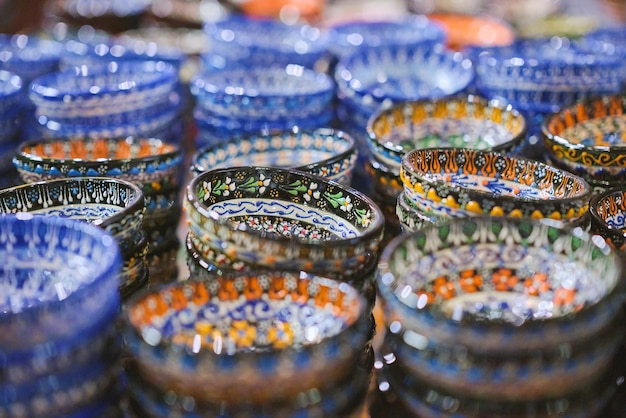 Traditional Turkish ceramics pottery bowl at the bazaar Selective focus and blurred background Gift ceramic bowls earthenware and handmade plates