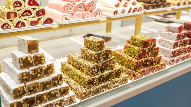 Traditional Turkish delight, sweets, nougat, on the market showcase in assortment. Selective focus.