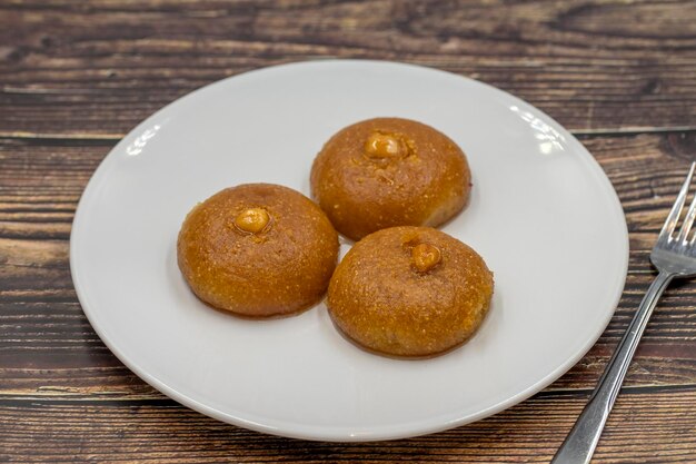 Traditional Turkish dessert sekerpare on a wooden background Turkish dessert with syrup ramadan and feast treat Close up