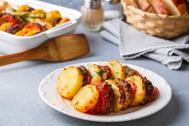 Traditional Turkish food; baked potatoes and meatballs. Turkish name; kofteli patates dizmesi, patates dizme