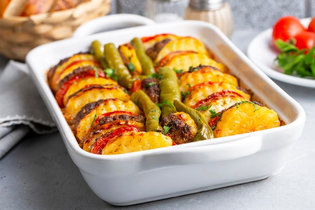 Traditional Turkish food; baked potatoes and meatballs. Turkish name; kofteli patates dizmesi, patates dizme