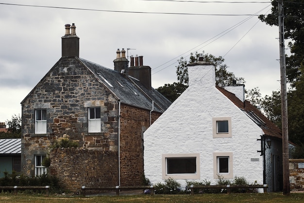 Traditional two old scottish houses with windows and smokestacks