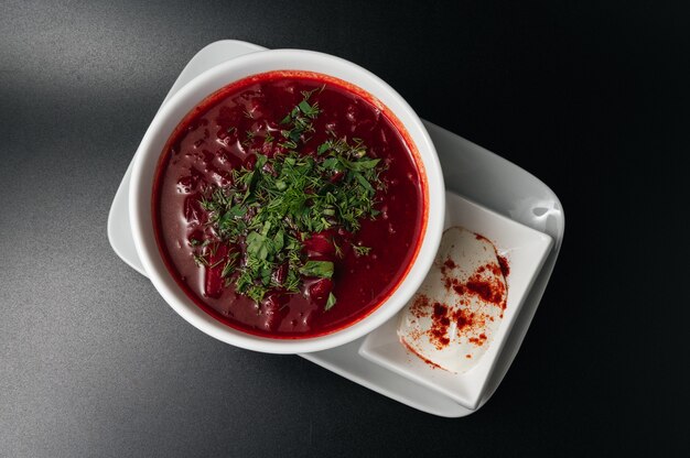 traditional ukrainian russian borscht  bowl of red beet root soup borsch with white cream