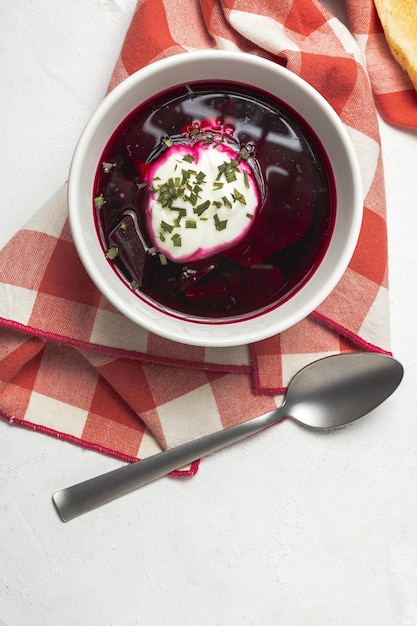 Traditional Ukrainian and Russian national red borscht soup in bowl with sour cream and herbs Healthy food concept