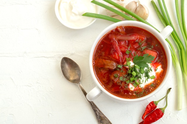 Traditional Ukrainian Russian soup (borscht) from beet with greens and sour cream.