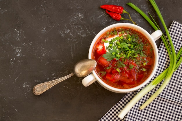 Traditional Ukrainian Russian soup (borscht) from beet with greens and sour cream.