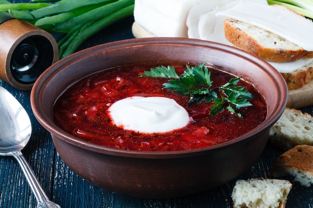 Traditional Ukrainian Russian vegetable borscht soup on the old wooden surface