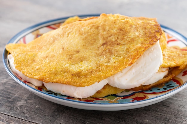 Traditional Venezuelan beef cachapa on wooden table