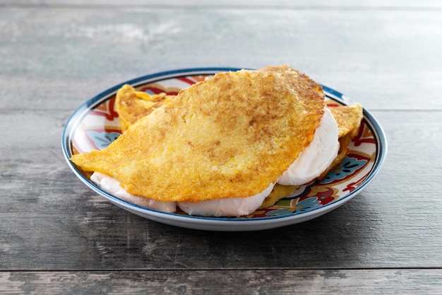 Traditional Venezuelan beef cachapa on wooden table