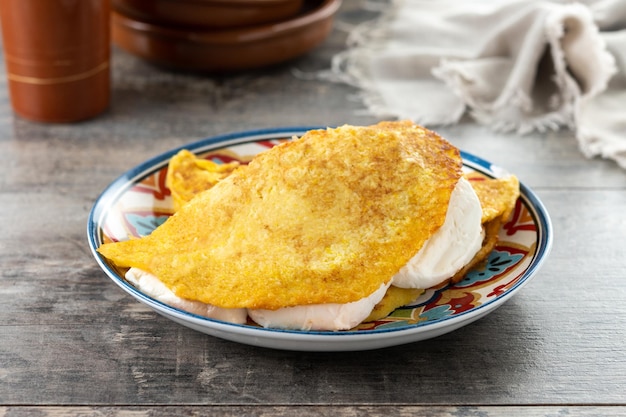 Traditional Venezuelan beef cachapa on wooden table