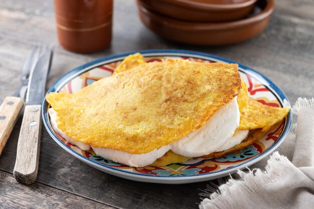 Traditional Venezuelan beef cachapa on wooden table