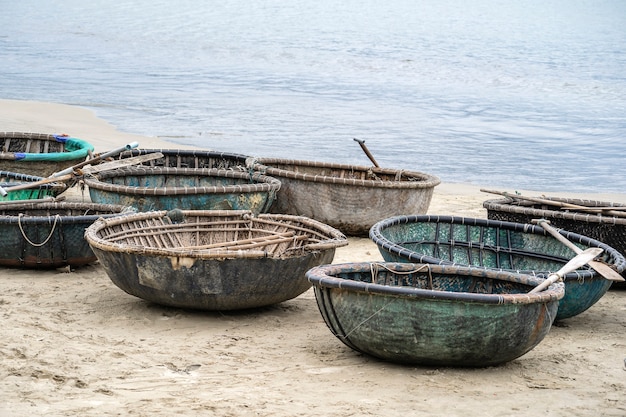 A traditional Vietnamese boat placed on a beach located in My Khe Beach