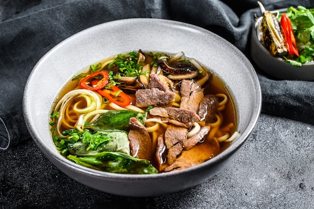 Traditional Vietnamese soup Pho bo with herbs, meat, rice noodles, broth