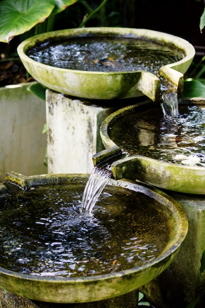 Traditional water fountain in asian botanical garden