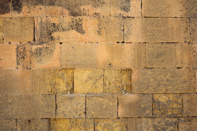 Traditional weathered stone wall background in malta