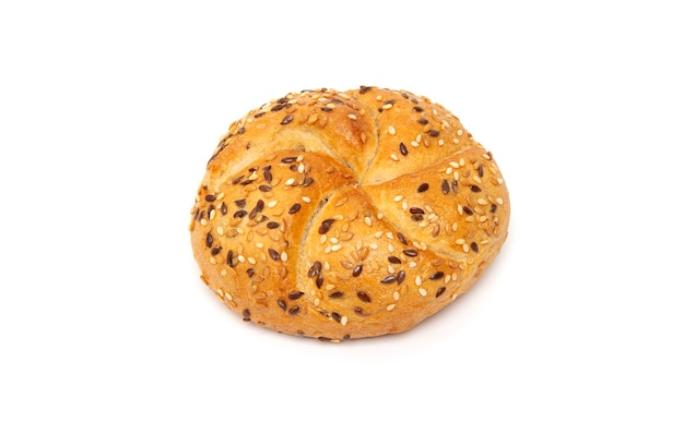 Traditional white kaiser roll with linseeds and sesame seeds isolated on white background