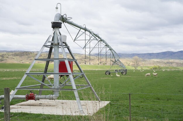 Traditional windmill on field against sky