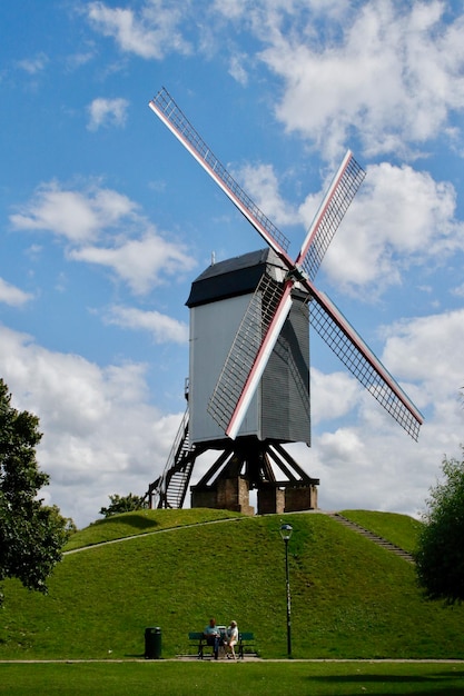 Traditional windmill on field against sky