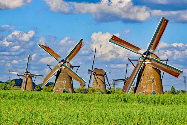 Traditional windmill on field against sky