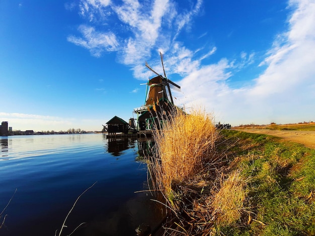 Traditional windmill on field against sky