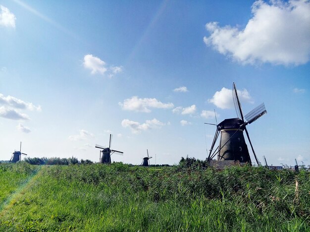 Traditional windmill on field against sky