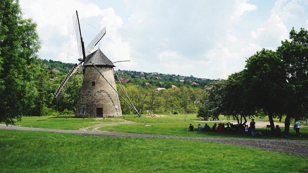 Traditional windmill on field against sky