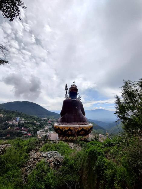 Traditional windmill on mountain against sky