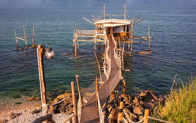 A traditional wooden fishing trabocco in the sea in Italy