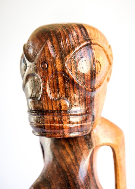 Traditional wooden Polynesian tiki from Marquesas Islands. Isolated on white background