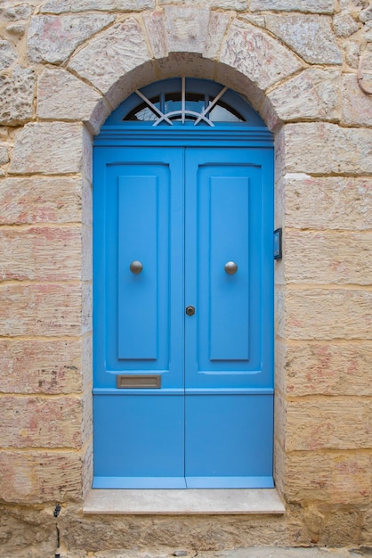 Traditional wooden vintage painted blue door in malta