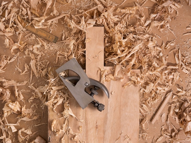 Traditional Woodworking, Iron plane on wooden cutting table and wood shavings. 