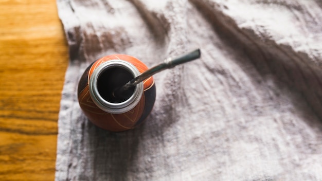 Photo traditional yerba mate cup standing on draping