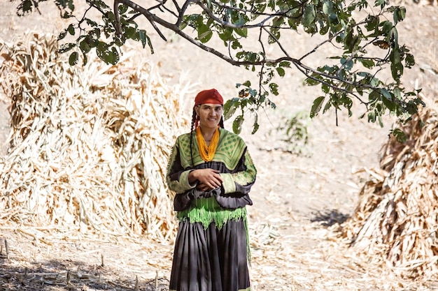 Traditionally dressed Kalash tribe woman smiling in Kalash Valley village Pakistan